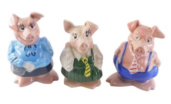 Three Wade NatWest piggy banks, comprising two Fathers with stoppers, and a Daughter with stopper. (