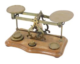 A set of late 19th/early 20thC walnut and brass letter scale, with some weights, 35cm wide.