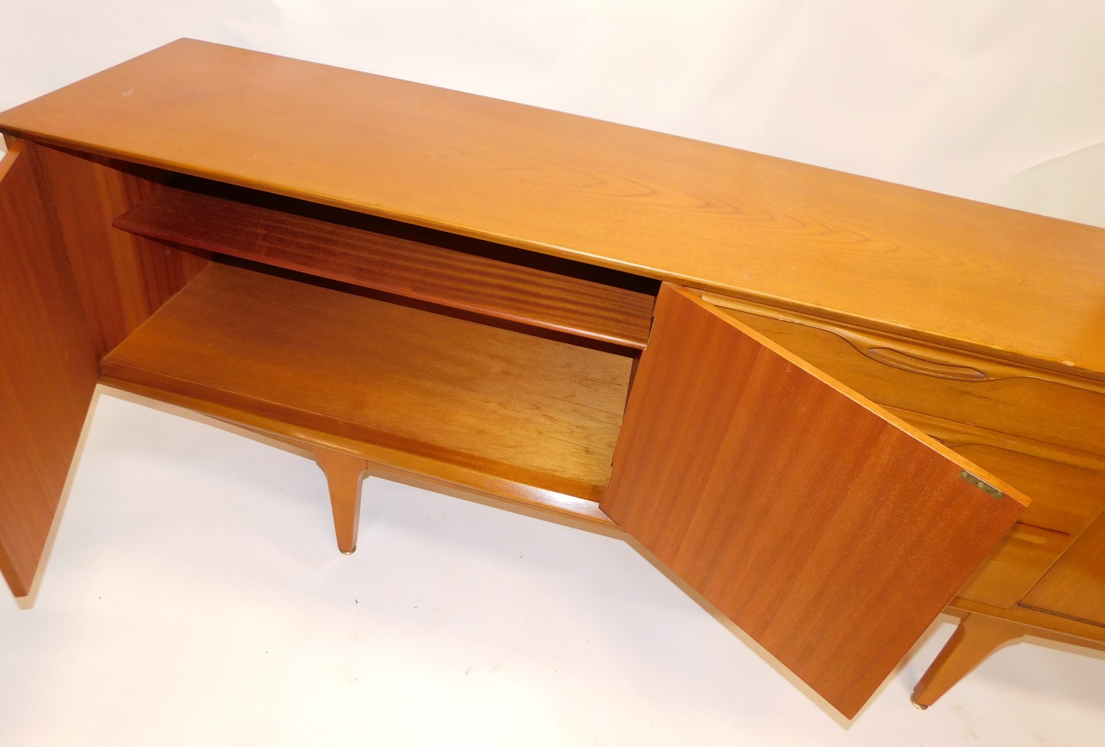 A 1960s/70s teak low sideboard, with arrangement of three drawers and three doors, on square taperin - Image 3 of 4