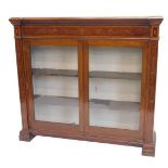 A late 19th/early 20thC mahogany satinwood and marquetry bookcase, the inverted break front top with