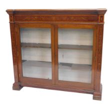 A late 19th/early 20thC mahogany satinwood and marquetry bookcase, the inverted break front top with
