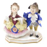 A Continental porcelain figure group, modelled in the form of two children in 18thC dress, on shaped