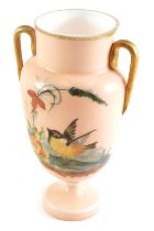 A Victorian opaque glass two handled vase, painted with birds and flowers, on a coral coloured groun