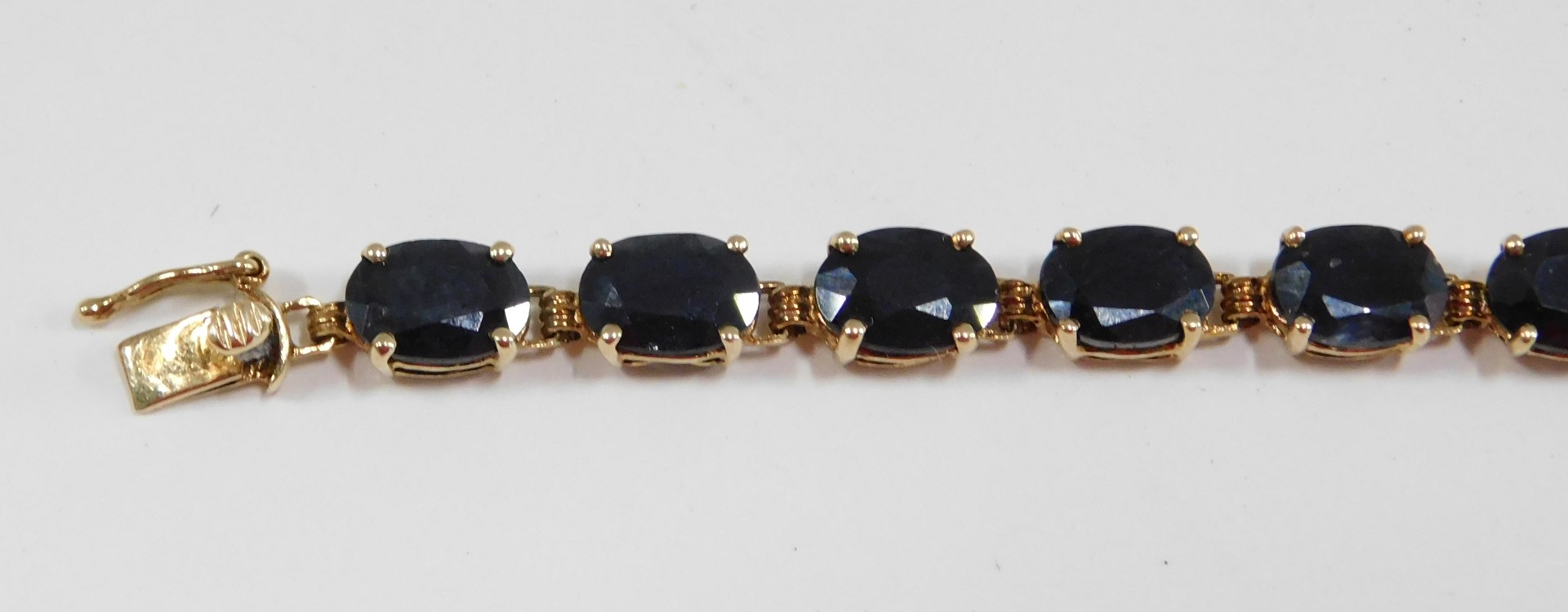 A sapphire set line bracelet, with oval sapphires, in claw mount, on yellow metal bracelet stamped 1 - Image 2 of 4