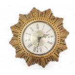 A Smiths wall clock, in gilt star shaped case, 25cm diameter.