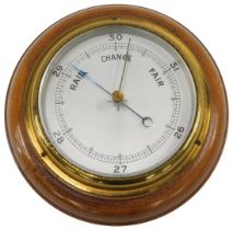 An aneroid barometer with silvered dial, in mahogany case, 18cm diameter.