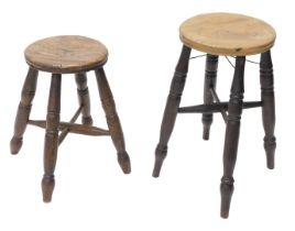 A late 19th/early 20thC workshop stool, with a circular elm seat and turned legs, with X stretcher,