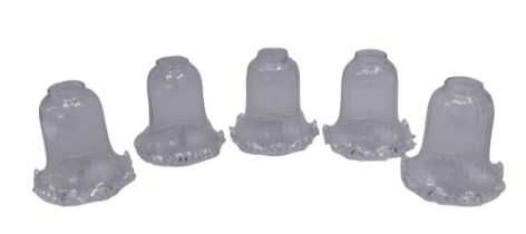 A collection of five clear glass ceiling light shades, with shaped edge.