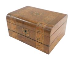 A Victorian walnut and parquetry writing box, the hinged lid enclosing a fitted interior, 30cm wide.