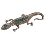 A 1950s lizard brooch, set with arrangement of green, white and red paste stones, in white metal set