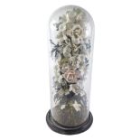 A 19thC Victorian style ceramic and composition flower arrangement or display, on a naturalistic bas