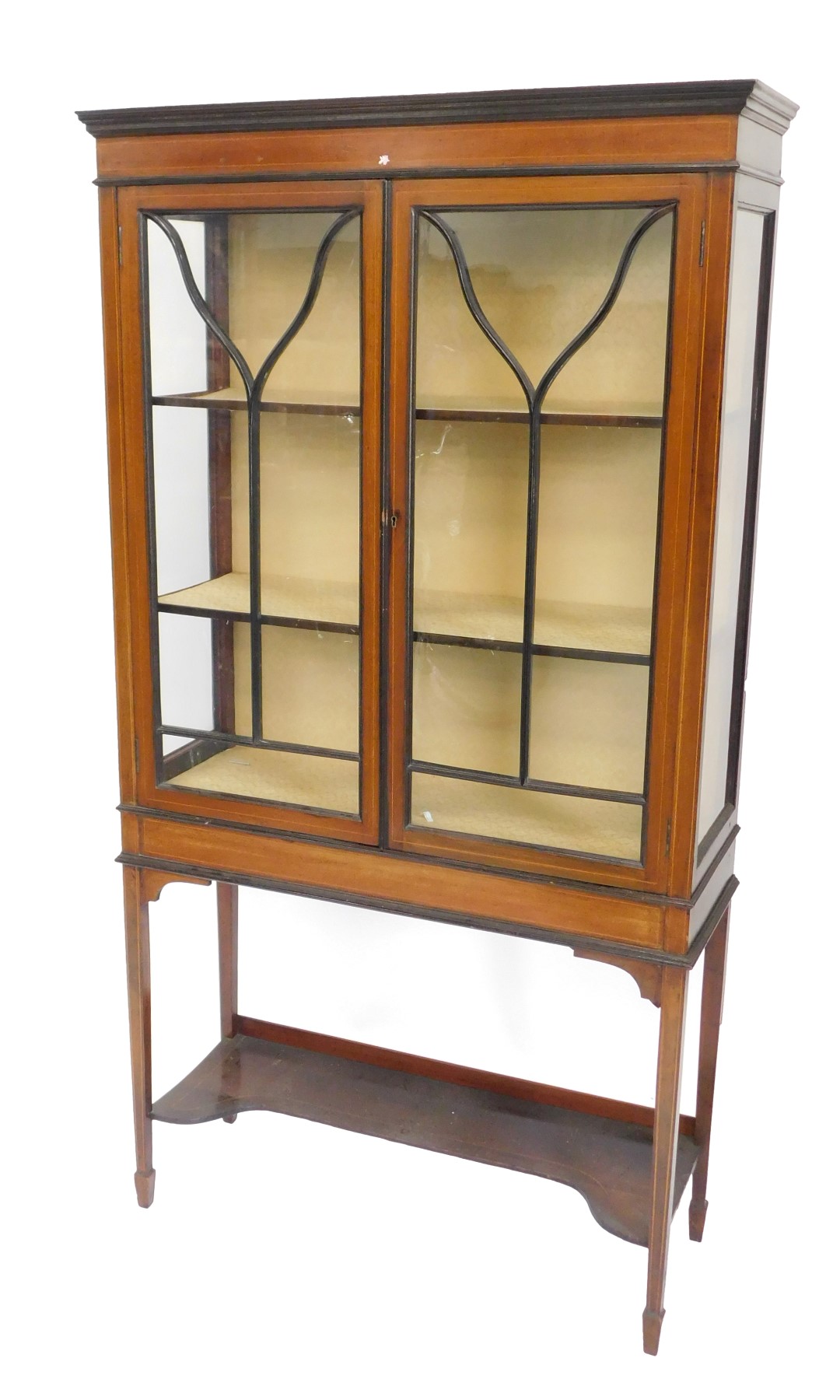 An Edwardian mahogany and boxwood strung display cabinet, with two glazed doors, on square tapering