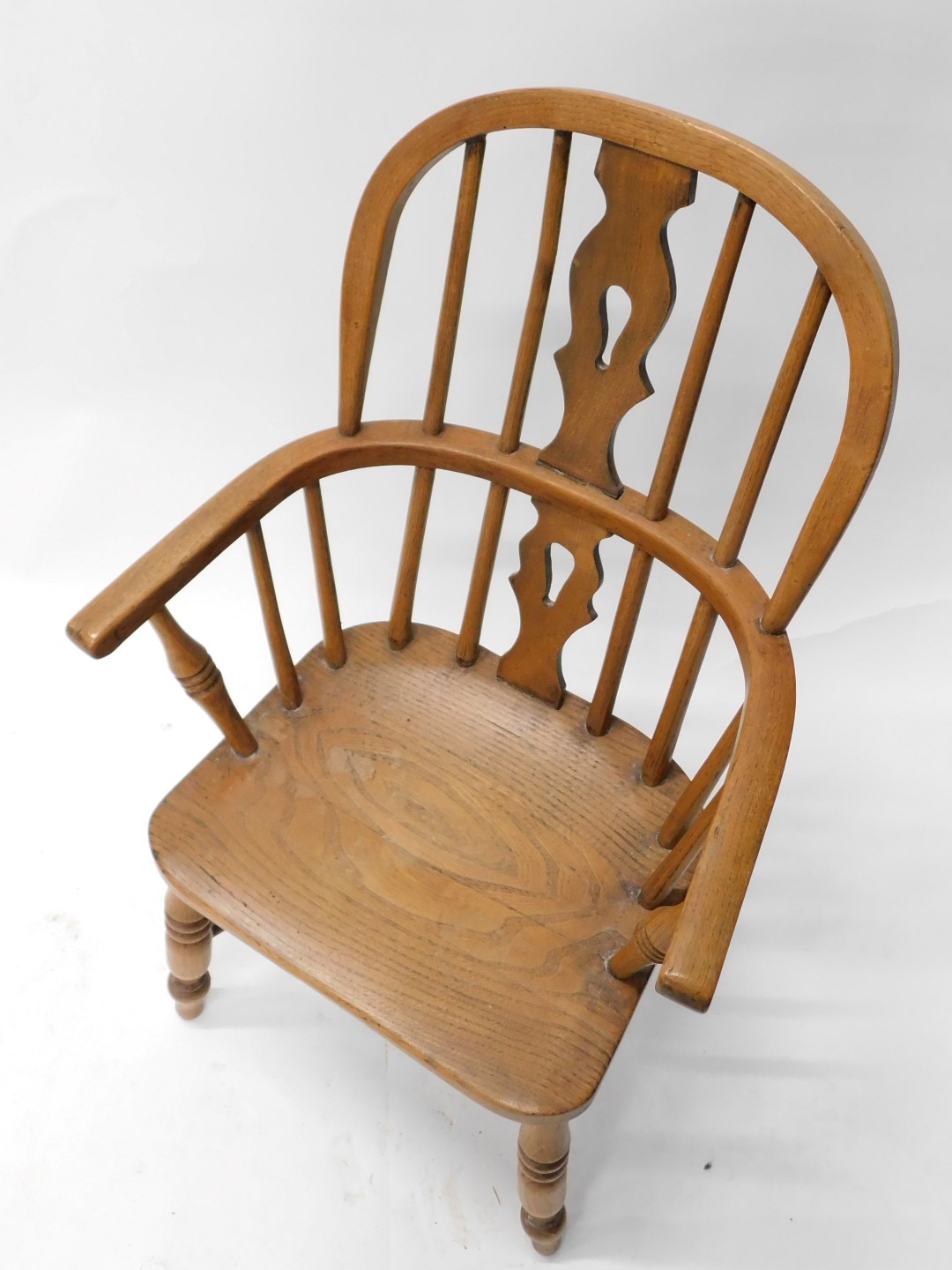 An ash and elm child's Windsor open armchair, with a pierced splat, solid seat, on turned legs, with - Image 2 of 3