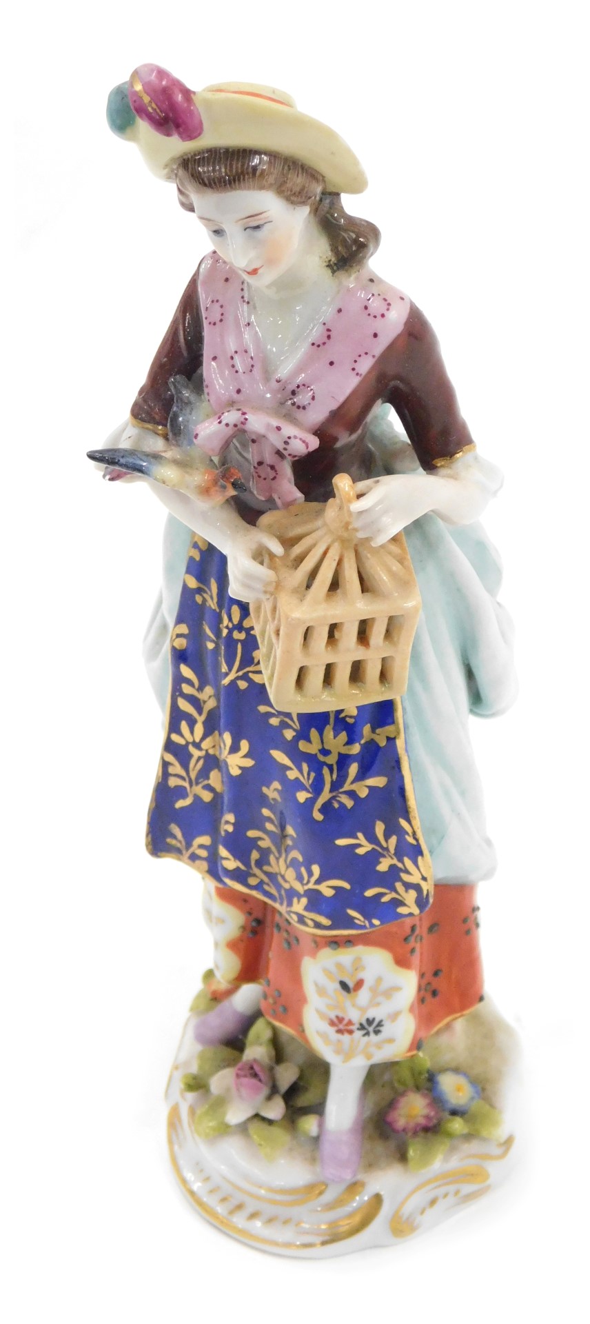 A Continental porcelain figure, modelled in the form of a lady with a bird and cage, gold anchor mar