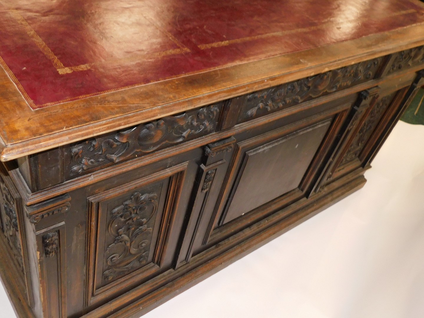 A Continental carved oak pedestal desk, the rectangular top with an ox blood red leatherette inset, - Image 6 of 6