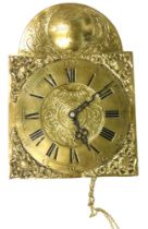 A brass wall clock, signed Paul Wiedeman, with an arched top and Roman numerals, with pendulum