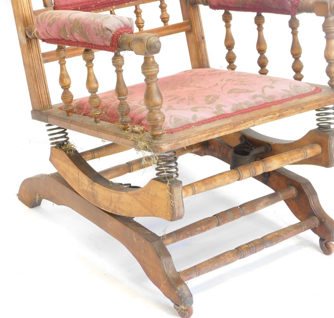 A late 19thC American walnut rocking chair, with a padded back, arm rest and seat, with turned stret - Image 2 of 2