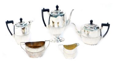 An Edwardian silver five piece tea and coffee set, of oval semi-fluted design, comprising tea pot, c