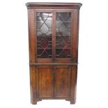 A George III oak standing corner cabinet, with a moulded cornice with two astragal glazed doors, the