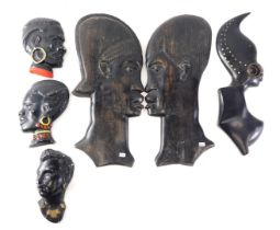 A pair of African wall plaques, each modelled in the form of a bust of a warrior, 36cm high, and oth