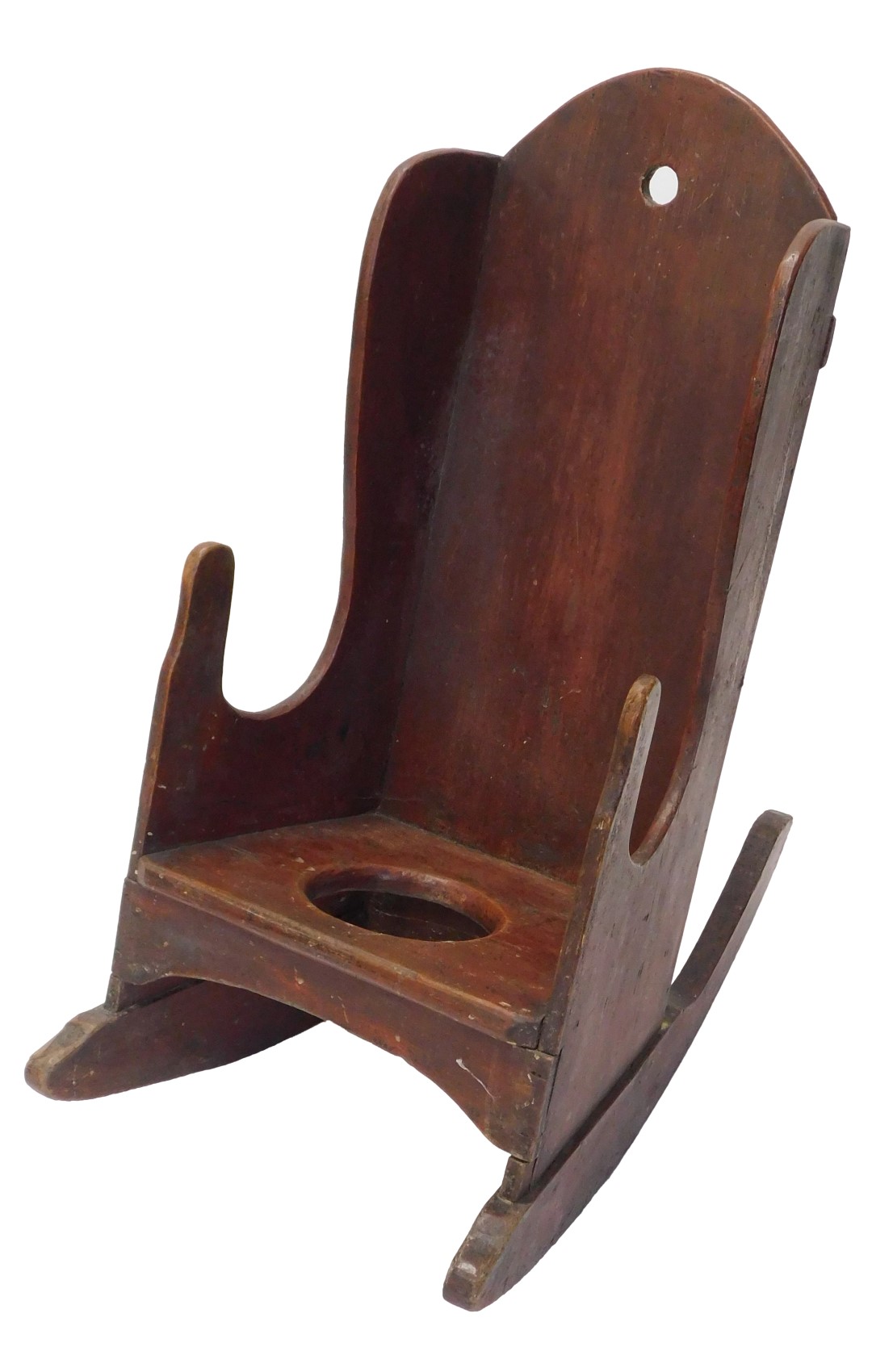 A 19thC country made child's red stained pine commode rocking chair, with shaped back.