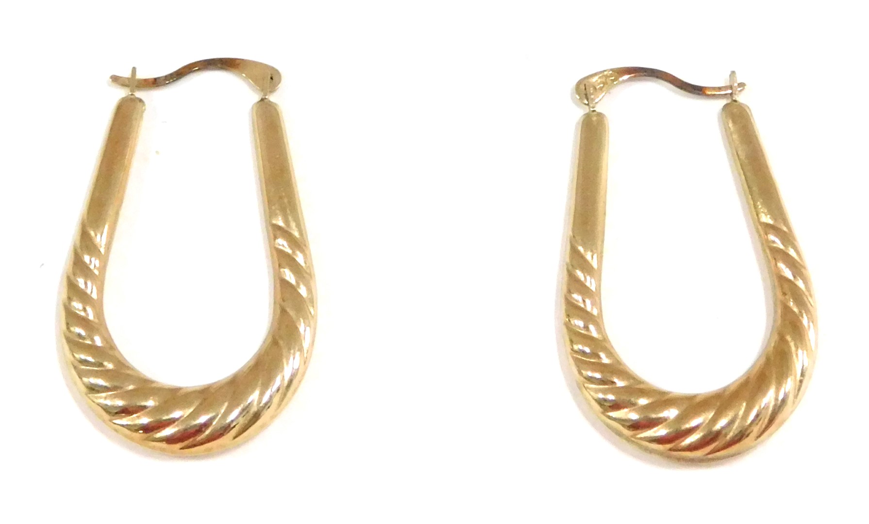 A pair of hoop earrings, the elongated hoops of twist design, yellow metal stamped 375, 3cm drop, 1.