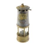 A Protector brass and steel miner's lamp, numbered 73, AF, 25cm high.