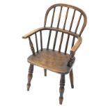 A child's ash and elm Windsor open armchair, with spindled turned back, solid seat, on turned legs.