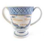 An early 19thC pearlware loving cup, named William Shaw and dated 1805, 13cm high. (AF)
