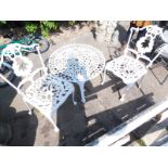 A painted cast iron garden set, comprising table and two chairs.