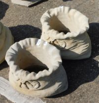 A pair of small sack shaped planters, each with a fluted top and bow, 26cm high, 31cm wide. (2)