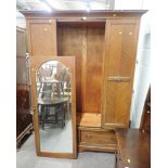 A 20thC mahogany double wardrobe, with mirror glazed door above arrangement of two drawers.