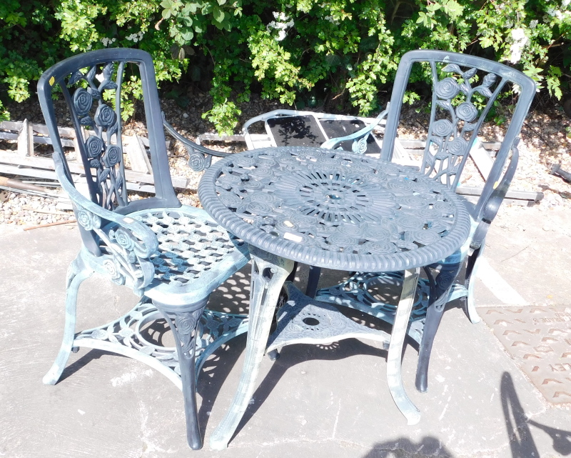 A plastic garden set, comprising two tier table and pair of armchairs.