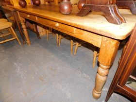 A large rustic pine rectangular kitchen table, with two drawers, 77cm high, 183cm wide, 82cm deep.