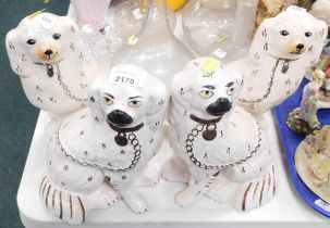 Two pairs of Staffordshire style pottery spaniels.