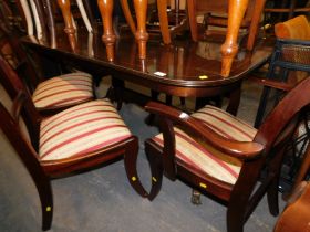 A reproduction mahogany twin pedestal dining table, and set of six dining chairs. The upholstery in