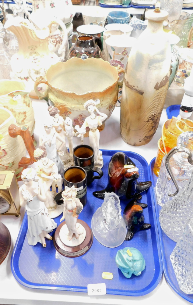 Various figures in 1920s and Edwardian dress, together with two pottery seals, glass moulded paperwe