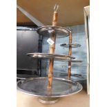 A pair of Two's Company three tier cake stands, each with a hammered circular graduated steel plate,