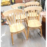 A set of four beech effect stick back kitchen chairs.
