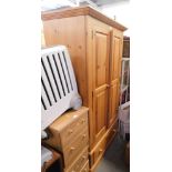 A pine double wardrobe, with two cupboard doors and single drawer.