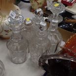 Five decanters, differing shapes and designs.