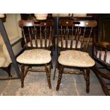 A set of four stained beech pub chairs, each with gold leaf pattern upholstery. The upholstery in t