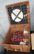 A wicker picnic hamper and contents.