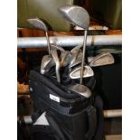 A Powakaddy soft shell golf carry bag and collection of Report, Ben Sayers and Ping golf clubs. Buy