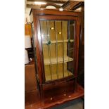 A mid 20thC mahogany boxwood inlaid display cabinet, with stained glass panelled door, on stiles, an