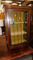 A mid 20thC mahogany boxwood inlaid display cabinet, with stained glass panelled door, on stiles, an