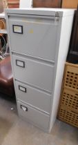 A four drawer metal filing cabinet, with key.