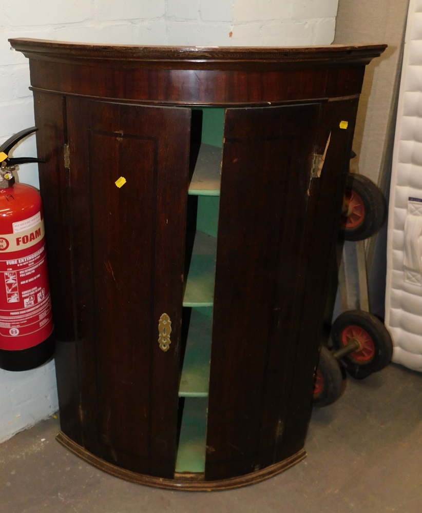 A George III oak and mahogany corner cupboard. (AF)