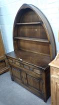 An Old Charm style dresser, with arched back above two shelves, two single drawers with two cupboard