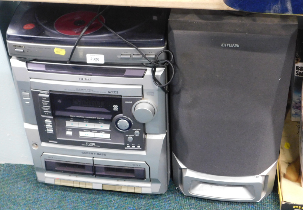 An Aiwa sound system, comprising turn table, PX-E80, rotary changer system, and two speakers.